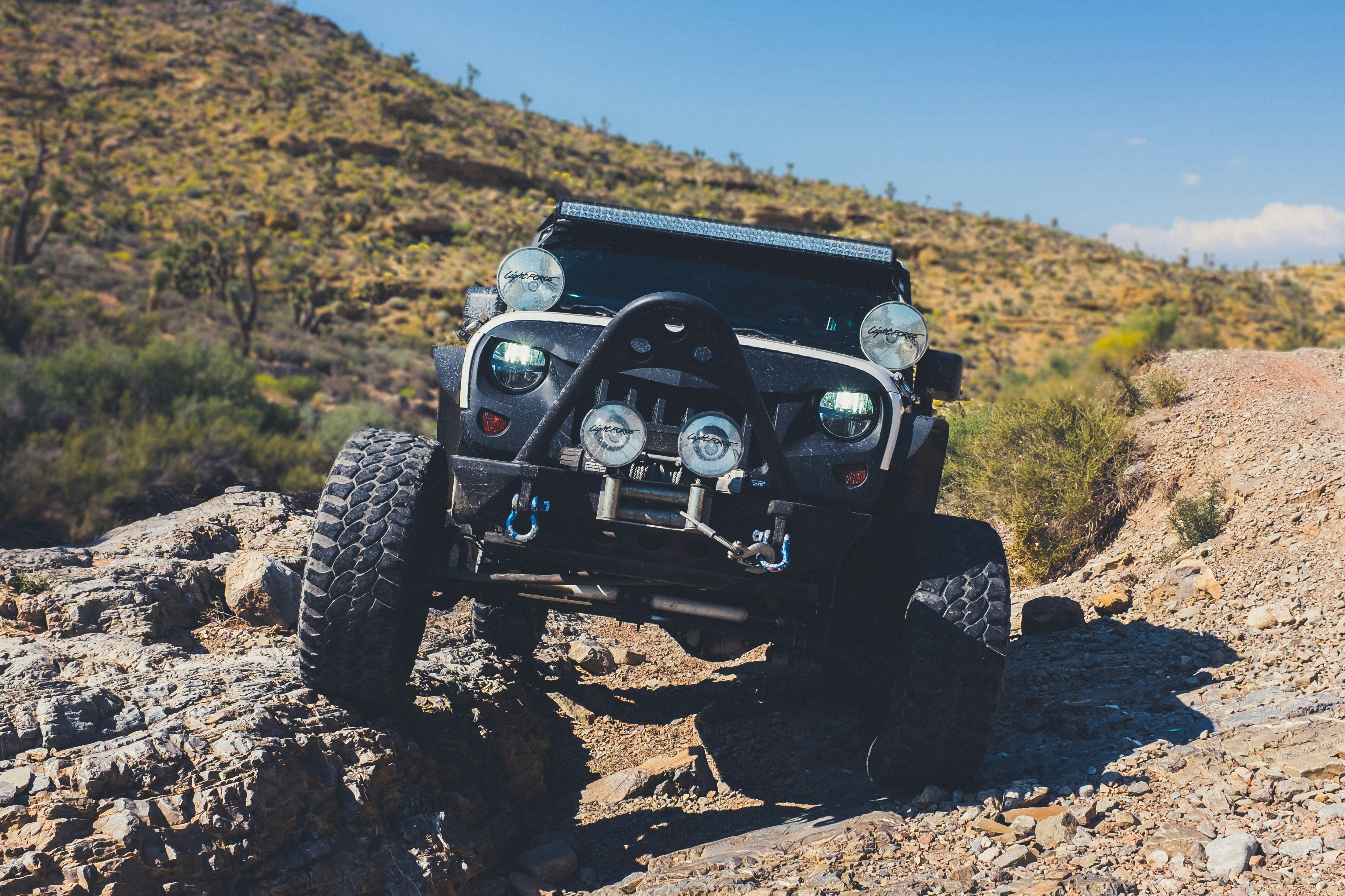 black Jeep Wrangler on land during daytime